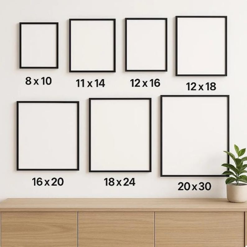 May include: A selection of framed art prints in various sizes, including 8x10, 11x14, 12x16, 12x18, 16x20, 18x24, and 20x30 inches (approx. 20x25cm, 28x36cm, 30x41cm, 30x46cm, 41x51cm, 46x61cm, 51x76cm). Black frames are displayed on a white wall above a wooden cabinet.