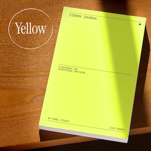 May include: A bright yellow notebook with the text "CINEMA JOURNAL" at the top. The notebook also has the text "A NOTEBOOK FOR INTENTIONAL WATCHING" and "BY K&Uuml;&Ntilde;EL STUDIO". The notebook has 120 pages.