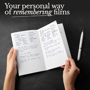 May include: A notebook with handwritten movie reviews, held open to display notes and ratings. A white pen rests on the dark surface. The text at the top reads "Your personal way of remembering films."
