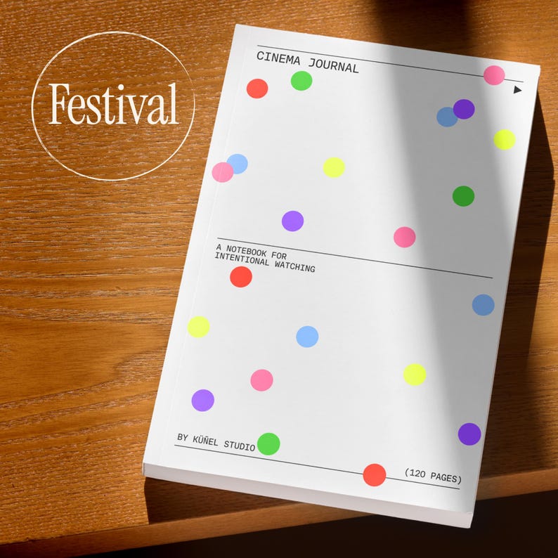 May include: A white notebook with colorful polka dots and the text "CINEMA JOURNAL." The cover also features the text "A NOTEBOOK FOR INTENTIONAL WATCHING" and "BY K&Uuml;&Ntilde;EL STUDIO." The notebook has 120 pages.