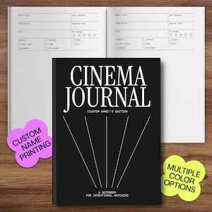 May include: A black "Cinema Journal" notebook with white text and lines, open to a dotted page. Includes stickers that say "Custom Name Printing" and "Multiple Color Options".