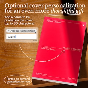 May include: A red notebook with the text "CINEMA JOURNAL" and "CLAIRE'S EDITION" printed on the cover. The notebook is shown on a wooden surface. The text "Printed on demand, created just for you" is also visible.