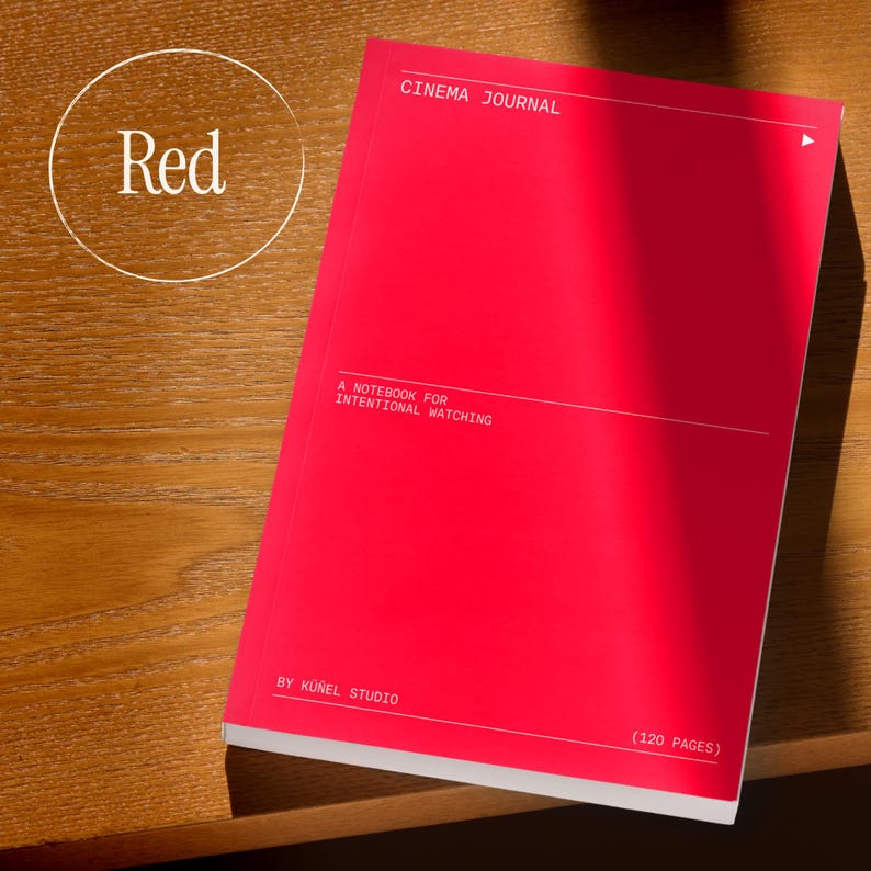 May include: A bright red notebook with the text "CINEMA JOURNAL" and "A NOTEBOOK FOR INTENTIONAL WATCHING." The notebook has 120 pages and is by K&uuml;nel Studio. The word "Red" is in a white circle in the upper left corner.