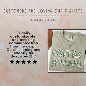 May include: A sage green t-shirt featuring the word MOM in large block letters with a white and green floral pattern. The text CUSTOM UNIVERSITY is printed across the center, with EST. 2026 below. A five-star review is displayed to the left.