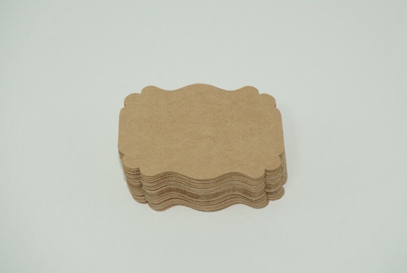 May include: A stack of brown, scalloped paper gift tags.
