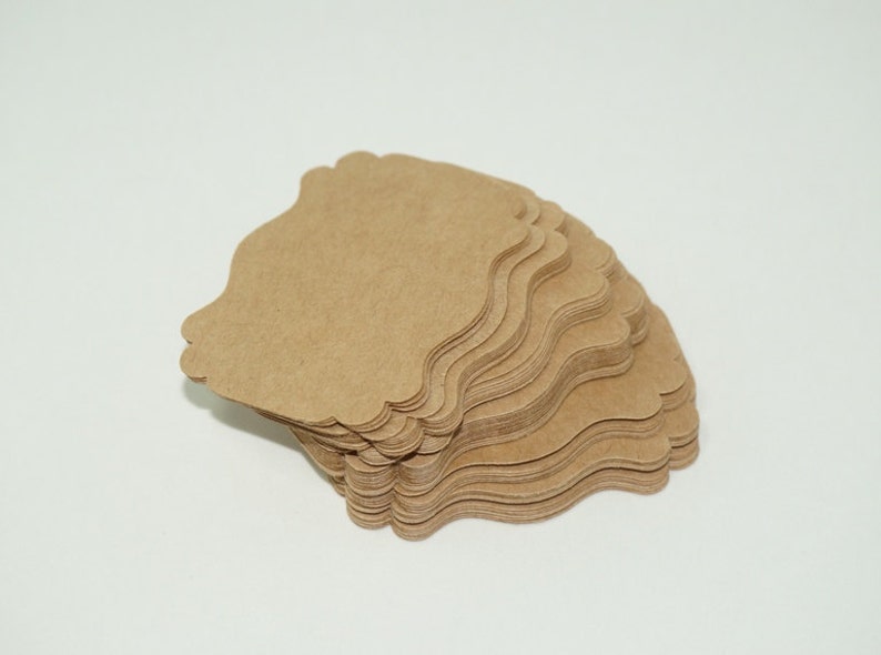 May include: A stack of brown, scalloped paper gift tags.