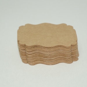 May include: A stack of brown, scalloped paper gift tags.