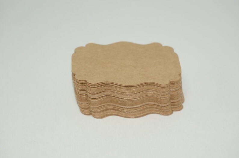 May include: A stack of brown, scalloped paper gift tags.