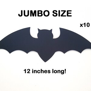 May include: A black bat-shaped decoration with a wingspan of 12 inches. The image includes the text "JUMBO SIZE" and "x10 pcs". This Halloween-themed decoration is perfect for adding a spooky touch to any space.