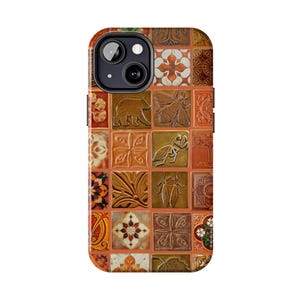 May include: A phone case featuring a mosaic design with various embossed images of animals and floral patterns. The case has a mix of warm colors, including orange, brown, and tan. The case is designed for a smartphone with a camera.
