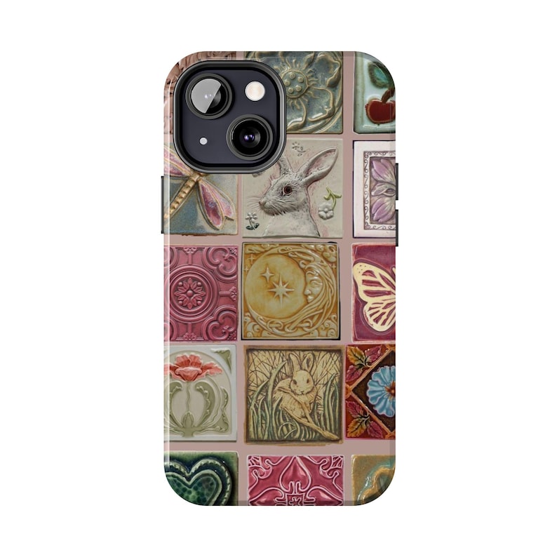 May include: A phone case featuring a collage of square tiles with various designs. The tiles include images of a rabbit, a butterfly, a dragonfly, flowers, and celestial elements. The color palette includes pink, green, and gold.