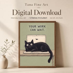 May include: A digital download wall art print featuring a black cat lying on a laptop keyboard on a desk. The text above the cat reads, "YOUR WORK CAN WAIT." The background is a muted sage green, and the illustration is framed in a dark wood border.