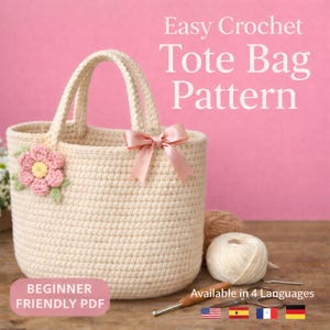 May include: A cream-colored crochet tote bag with a pink flower and bow. The bag has two handles and is decorated with a pink bow. Text on the image reads "Easy Crochet Tote Bag Pattern" and "Beginner Friendly PDF".