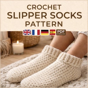 May include: Cream-colored crochet slipper socks. The socks are thick and textured, with a ribbed cuff. The image includes the text "CROCHET SLIPPER SOCKS PATTERN" and flags of the UK, France, Germany, and Spain, along with a "PDF DOWNLOAD" icon.