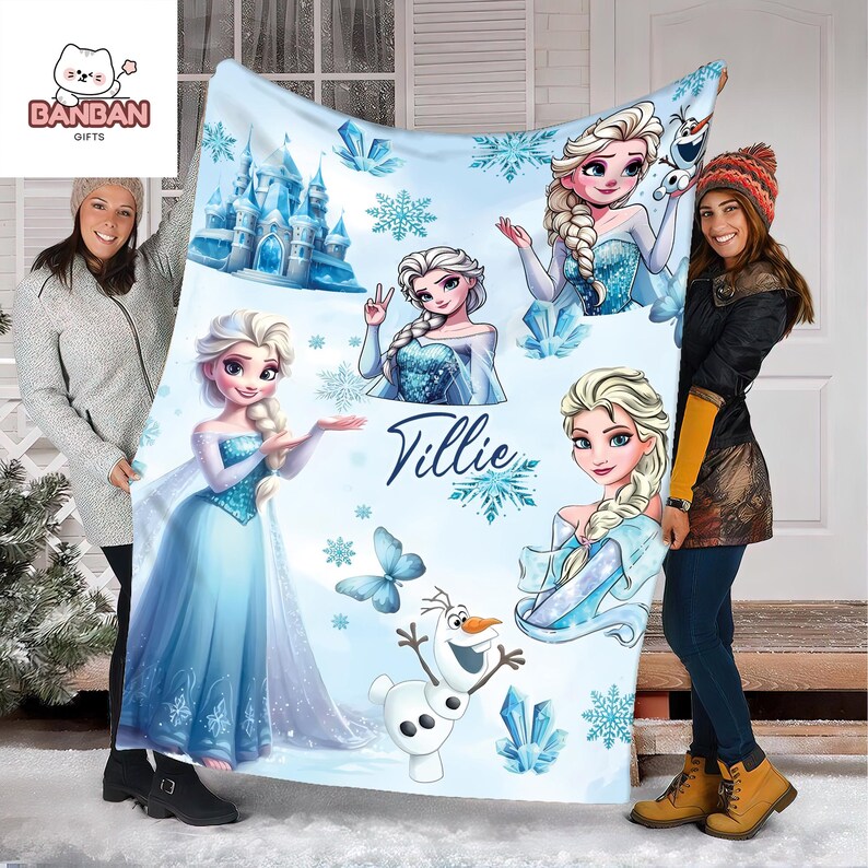 two women holding up a large blanket with illustrations of characters from the Disney movie Frozen.