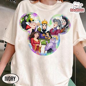 A white t-shirt with a colorful graphic design featuring characters from the Disney animated film "The Evil Queen".