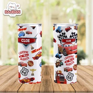 two cylindrical containers with a design inspired by the Cars movie franchise. The design includes various cars, trucks, and other elements commonly associated with the movie, such as lightning bolts and checkered flags. The containers are placed on a wooden surface, and the background is blurred, drawing attention to the design on the containers.