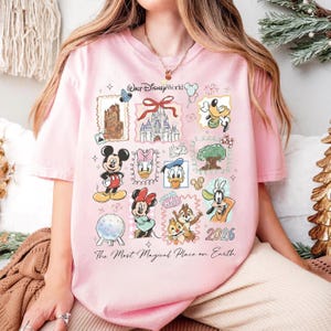 A woman wearing a pink t-shirt with various Disney characters and a text overlay that says "The Most Magical Place on Earth".