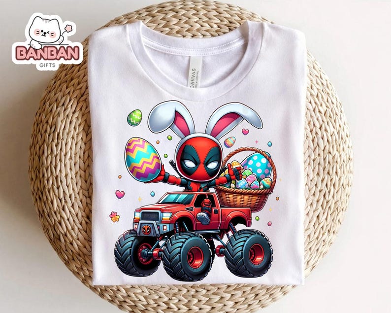 A white t-shirt with a graphic design depicting a character in a red and black costume riding a monster truck, holding a basket of Easter eggs.