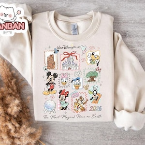 A white sweatshirt with a Disney World-themed graphic design, featuring various Disney characters and landmarks.