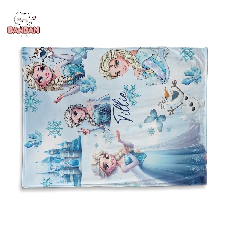 A blanket featuring various characters from the Disney movie Frozen, including Elsa, Olaf, and other popular characters. The blanket has a snowy, winter theme with snowflakes and a castle in the background.