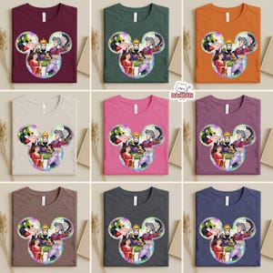 The image is a collage of nine t-shirts, each featuring a different color and design. The t-shirts are arranged in a 3x3 grid, with each row containing three shirts. The designs on the t-shirts include various characters and scenes from popular animated films and television shows.