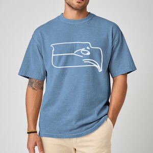 Championship winner t shirt featuring a Sam Darnold hand drawn logo shirt style graphic, Seattle football team meme shirt made for fans who appreciate funny Seattle sports t shirt designs, perfect gift for football fan shirt, unisex fit ideal for game day outfits, tailgates, watch parties, sports bars, casual wear, Seattle football fans, meme culture lovers, and bold sports themed apparel collectors