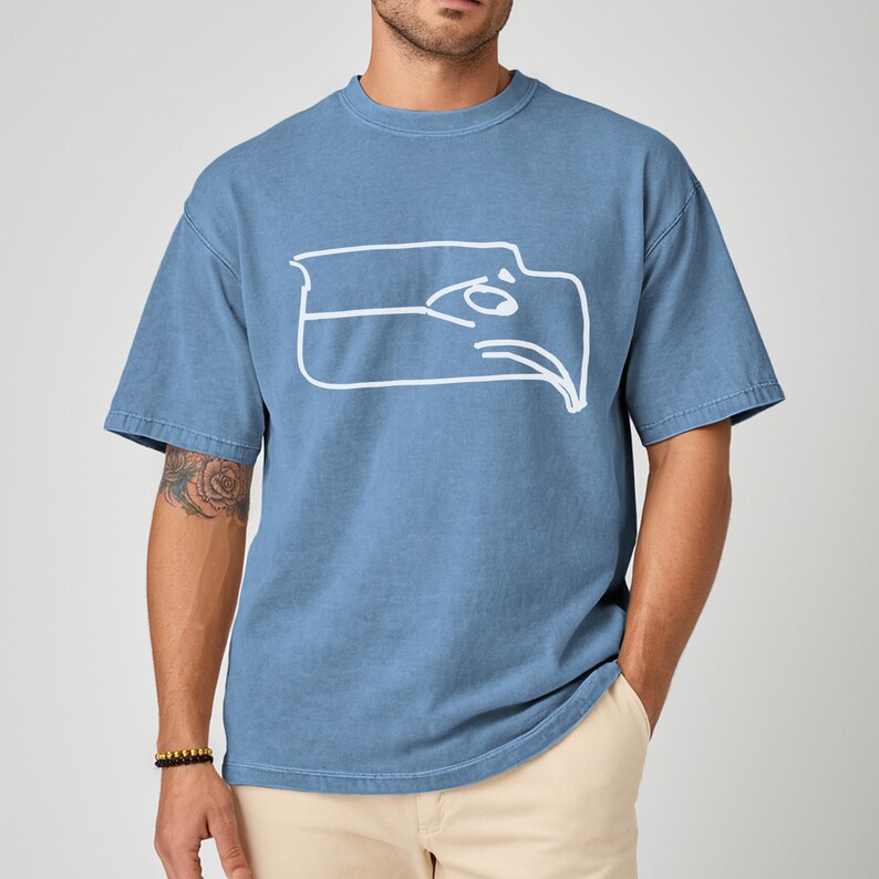 Championship winner t shirt featuring a Sam Darnold hand drawn logo shirt style graphic, Seattle football team meme shirt made for fans who appreciate funny Seattle sports t shirt designs, perfect gift for football fan shirt, unisex fit ideal for game day outfits, tailgates, watch parties, sports bars, casual wear, Seattle football fans, meme culture lovers, and bold sports themed apparel collectors