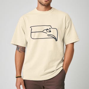 Seattle football team meme shirt designed as a Sam Darnold hand drawn logo shirt with humorous illustrated details, funny Seattle sports t shirt perfect for championship winner celebrations, ideal gift for football fan shirt, unisex football apparel great for game days, tailgating events, watch parties, casual wear, sports bar outfits, Seattle themed fan clothing, and meme lovers who enjoy playful sports fashion