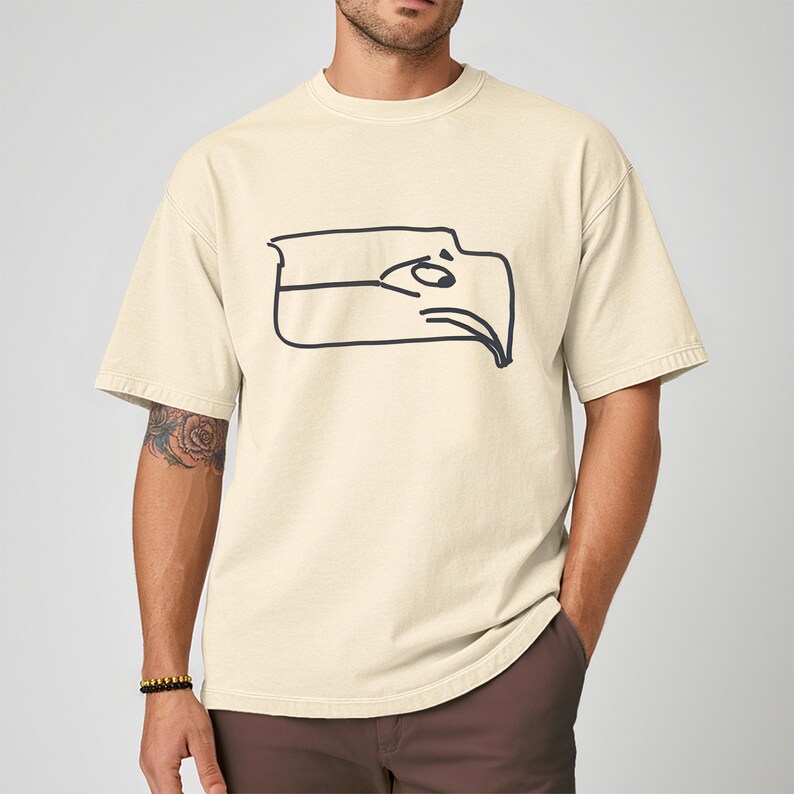 Seattle football team meme shirt designed as a Sam Darnold hand drawn logo shirt with humorous illustrated details, funny Seattle sports t shirt perfect for championship winner celebrations, ideal gift for football fan shirt, unisex football apparel great for game days, tailgating events, watch parties, casual wear, sports bar outfits, Seattle themed fan clothing, and meme lovers who enjoy playful sports fashion