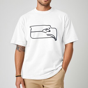 Funny Seattle sports t shirt showing a Sam Darnold hand drawn logo shirt design inspired by Seattle football team meme culture, championship winner t shirt created for fans who love humor and bold graphics, ideal gift for football fan shirt, unisex fit perfect for game day outfits, tailgates, watch parties, sports bars, casual everyday wear, and Seattle football supporters who enjoy meme inspired apparel