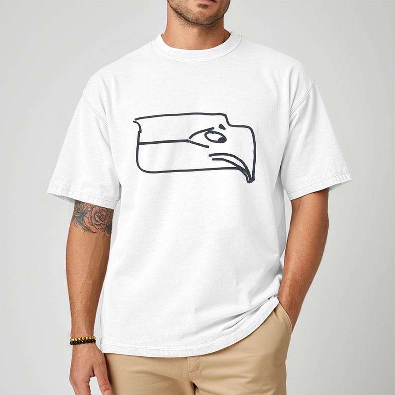 Funny Seattle sports t shirt showing a Sam Darnold hand drawn logo shirt design inspired by Seattle football team meme culture, championship winner t shirt created for fans who love humor and bold graphics, ideal gift for football fan shirt, unisex fit perfect for game day outfits, tailgates, watch parties, sports bars, casual everyday wear, and Seattle football supporters who enjoy meme inspired apparel