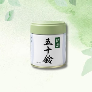 May include: A cylindrical container of matcha tea with a light green lid and a white label. The label features Japanese characters in black and a green square with more Japanese text. The brand name "ISUZU" is printed at the bottom.