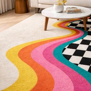 Colorful hand-tufted checkerboard area rug with vibrant curved rainbow-inspired stripes flowing across a plush ivory background into a classic black and white checkered design. Crafted from premium wool, this modern statement rug adds texture, warmth, and playful retro style to living rooms, bedrooms, creative studios, offices, and contemporary home interiors.