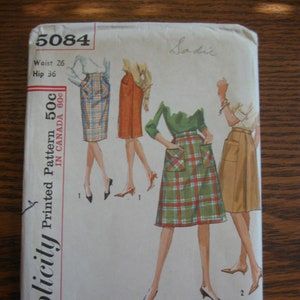 May include: Vintage Simplicity pattern envelope, featuring illustrations of pencil skirts with pockets in various colors and patterns. The envelope reads "5084" and includes measurements: Waist 26 inches, Hip 36 inches. The name "Sadie" is handwritten on the top.