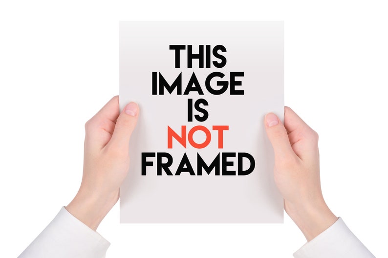 May include: A white rectangular paper held by two hands, with the text "THIS IMAGE IS NOT FRAMED" in black and red. The hands are in the foreground, and the background is white.