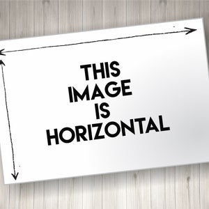 May include: A white rectangular sign with the text "THIS IMAGE IS HORIZONTAL" in bold black letters. The sign has black arrows and lines indicating its horizontal orientation. The background is a light wood grain.