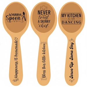 May include: Three wooden spoons with black text. One spoon says "wanna spoon?" and "Happiness is homemade". Another says "Never trust a skinny chef" and "Bless this little kitchen". The last says "My kitchen is for dancing" and "Serve up some joy".