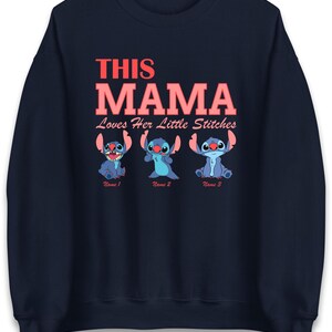 May include: Navy blue sweatshirt with the text "THIS MAMA Loves Her Little Stitches" in coral. Below the text are three blue cartoon characters. Each character has a name below it: Name 1, Name 2, and Name 3.