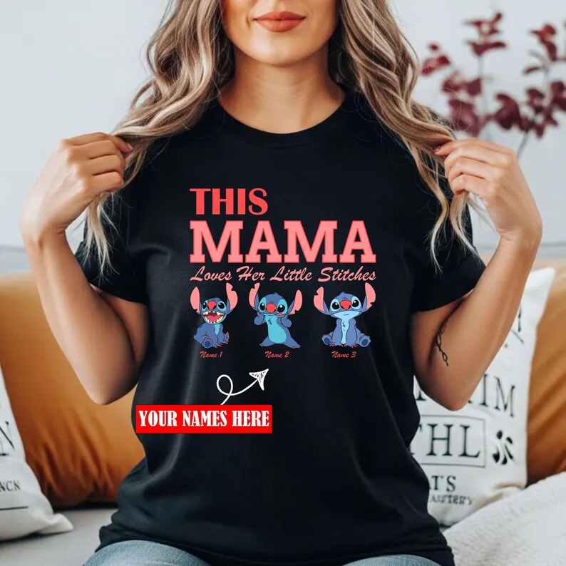 May include: Black t-shirt with the text "THIS MAMA Loves Her Little Stitches" in pink and red. Below are three blue cartoon characters. The shirt has a customizable area that says "YOUR NAMES HERE".