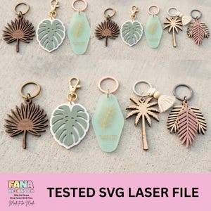 May include: A collection of keychains featuring various leaf and palm tree designs. The set includes dark wood fan-shaped leaves, sage green monstera leaves, light green motel-style tags with gold leaf prints, and palm tree charms with tassels.