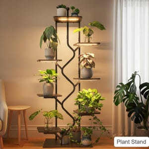 May include: A tall, dark metal plant stand with multiple wooden shelves, each illuminated by a small light. The stand is filled with various potted plants, showcasing a modern and stylish way to display greenery indoors. The text "Plant Stand" is visible.