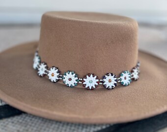 Beaded hat band.  White glass beads woven into a flower with with green, red and blue accents.