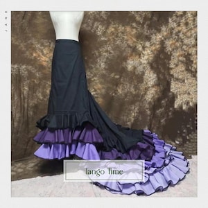 May include: A black and purple tango skirt with layered ruffles. The skirt has a long train and the text "Tango Time" is visible. The skirt is displayed on a mannequin.