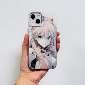 May include: A white phone case featuring a detailed anime illustration of a female character with long blonde hair and blue eyes. The case has a white camera module and the text "SO COOL" is printed on the side.