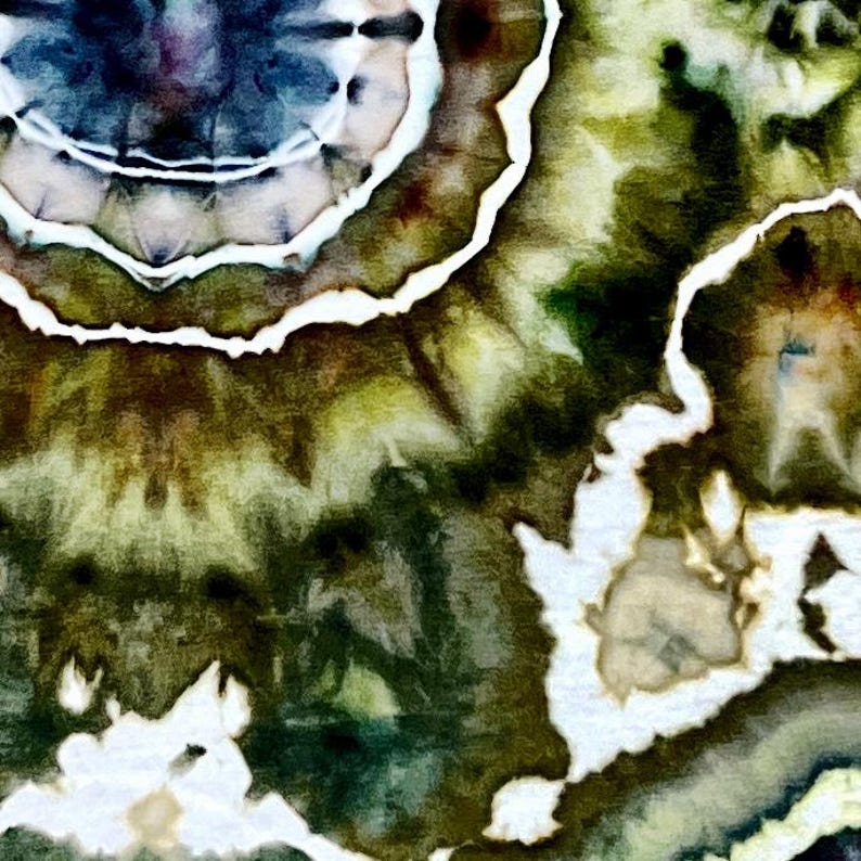 May include: A textile fabric featuring a tie-dye pattern with concentric circular shapes in shades of deep forest green, olive, and dark navy blue. The design includes distinct white lines that separate the color gradients, creating a high-contrast, organic, and fluid appearance across the surface of the material.