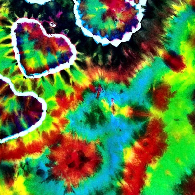 May include: A vibrant tie-dye design featuring a mix of colors including red, green, blue, and yellow. The design includes white heart shapes and circular patterns, creating a psychedelic and artistic look.