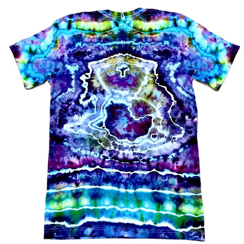 May include: A short-sleeved tie-dye t-shirt in a vibrant mix of colors. The shirt features a swirling pattern with shades of blue, purple, green, and white. The design includes a central, abstract shape outlined in white.