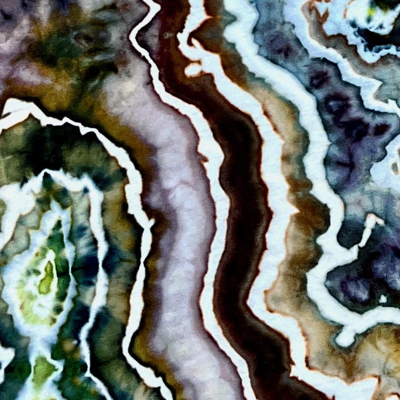 May include: A textile surface featuring a tie-dye pattern with organic, wavy bands of color. The design incorporates shades of deep brown, forest green, muted purple, and light blue, separated by distinct, irregular white lines throughout.