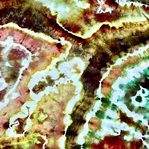 May include: Abstract textile art with a tie-dye effect. The design features a blend of colors, including red, green, yellow, and white, creating a unique and textured pattern. The artwork has a watercolor-like appearance.